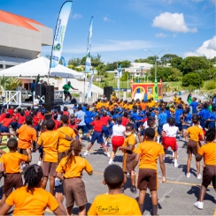 Large group of children outdoors performing physical activities
