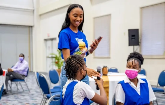 Student giving Ashley a microphone