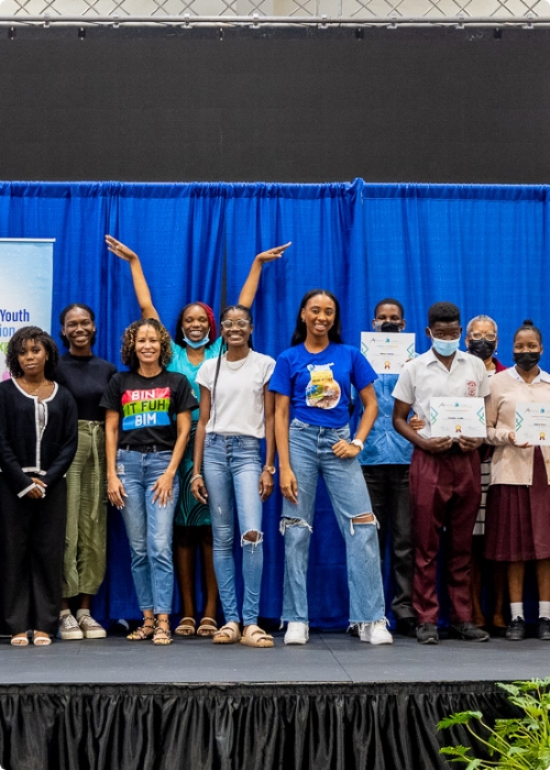 A group of youth on stage posing for photo.